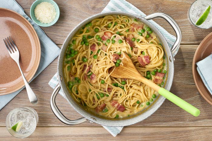 Pot of spaghetti carbonara sitting on table