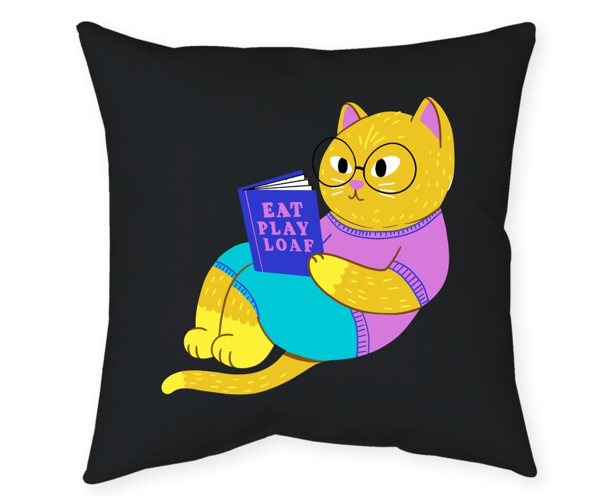 Black pillow with orange cat on it reading a book that says &quot;eat, play, loaf&quot;
