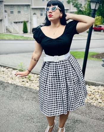 reviewer wearing the black and white checkered skirt