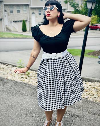 reviewer wearing the black and white checkered skirt