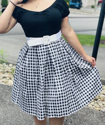 close up of reviewer wearing the black and white checkered skirt