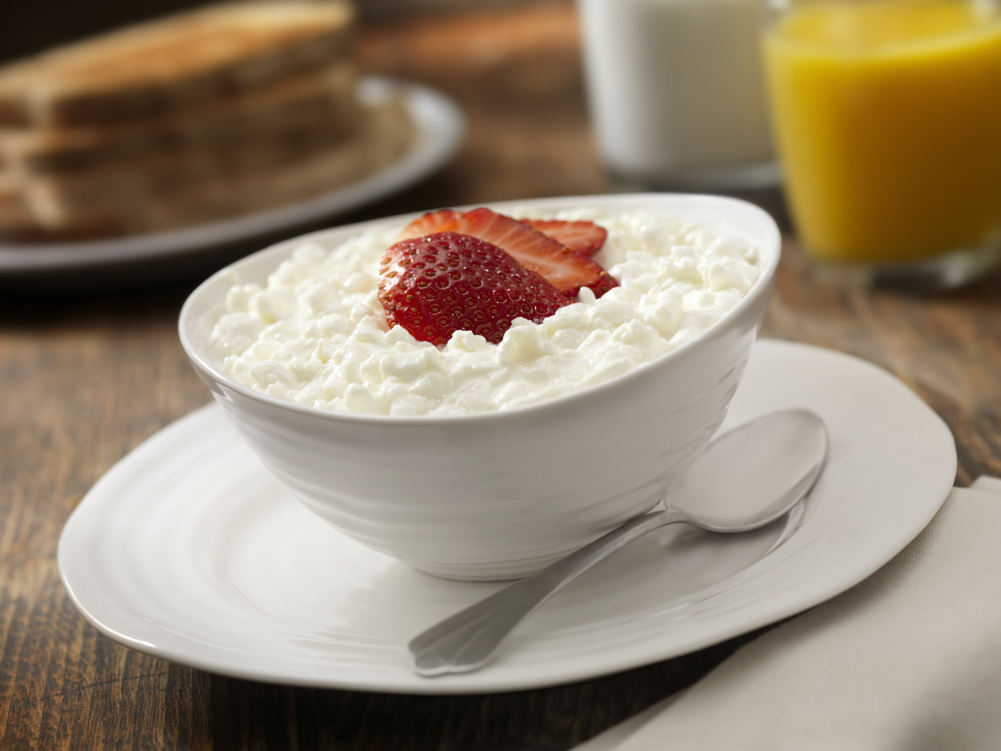 A small bowl of cottage cheese with fresh strawberries