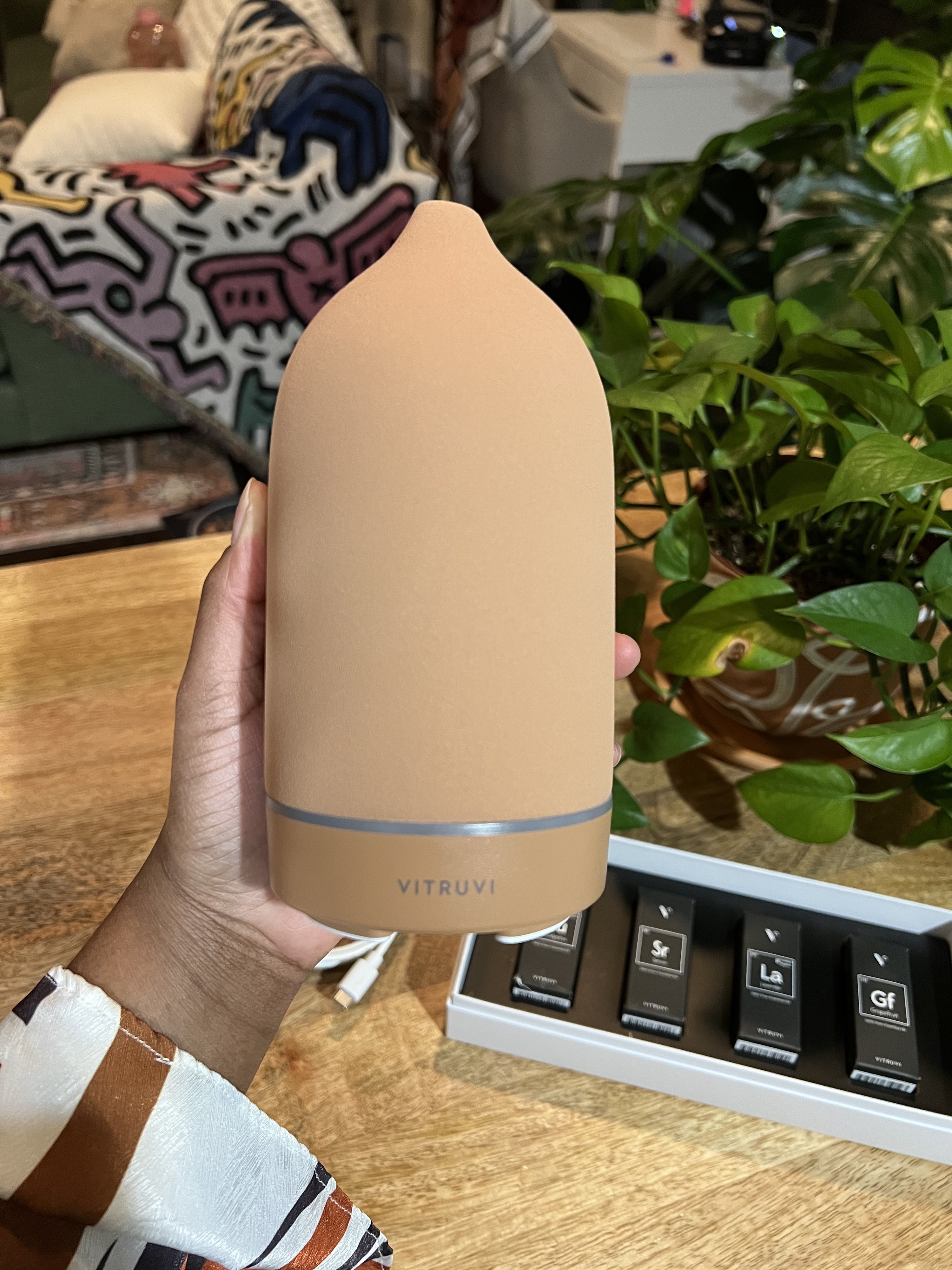 A reviewer holding the diffuser
