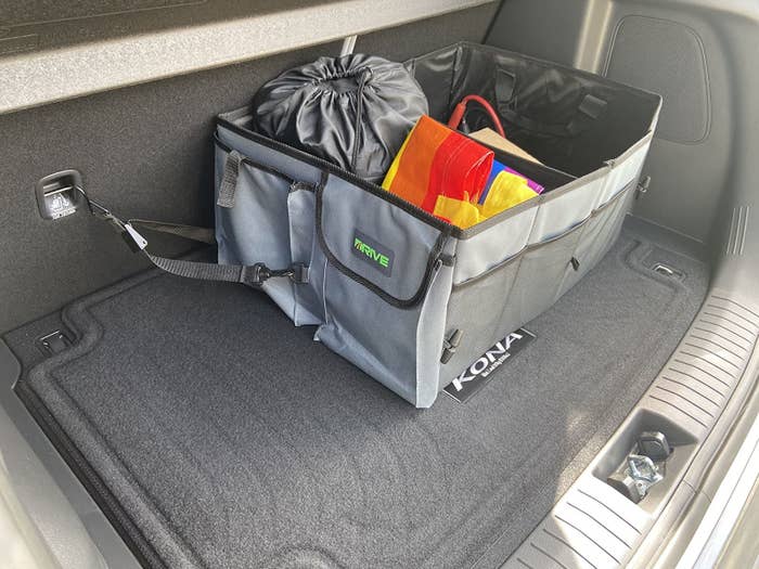 reviewer image of a full trunk organizer in the trunk of an SUV