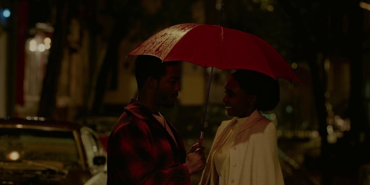 Clementine and Alonzo standing under an umbrella