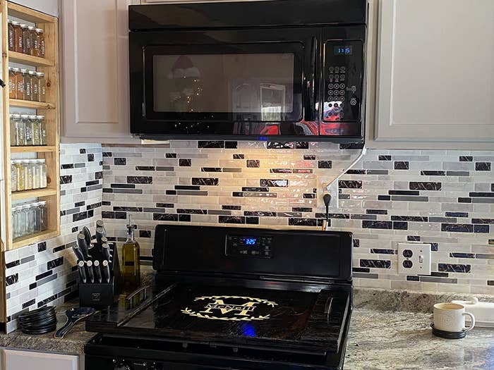 reviewer image of the gray marble peel and stick tile used as backsplash in a customer&#x27;s kitchen