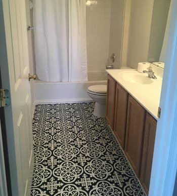 after image of the same bathroom with black medina floor tile
