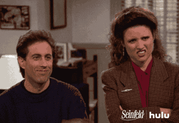 Jerry Seinfeld dramatically pinches his nose to avoid a smell