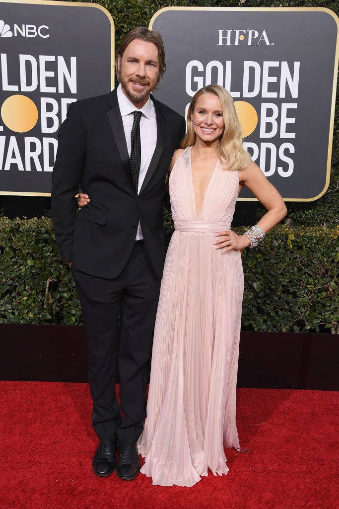 The couple arm-in-arm as they post on the Oscars red carpet