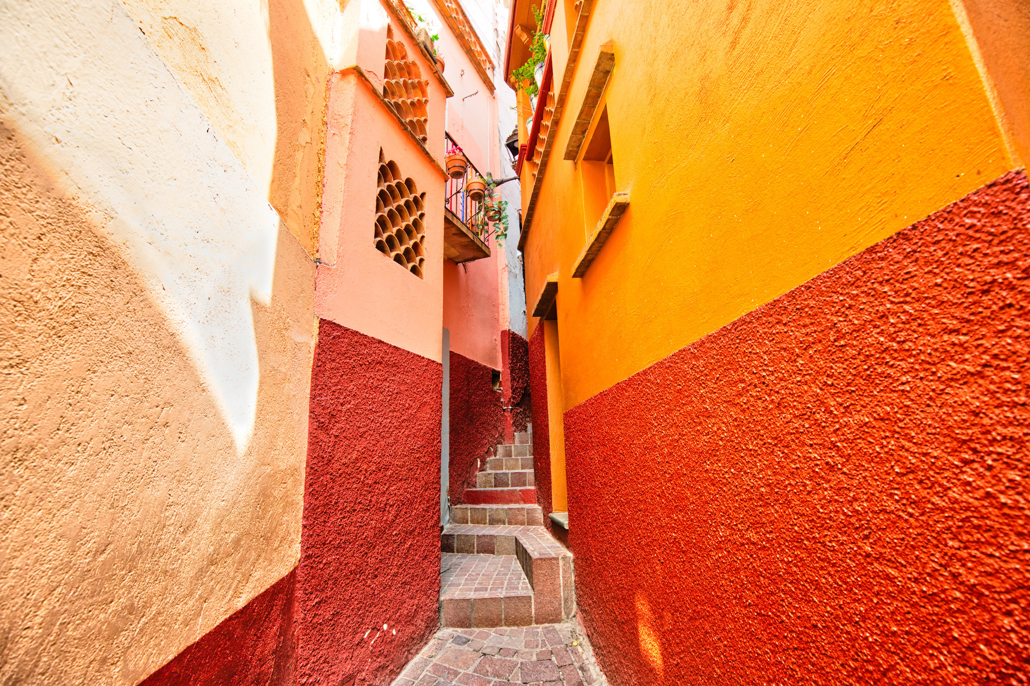 narrow steps alley between two painted buildings