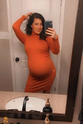 pregnant reviewer wearing body con dress