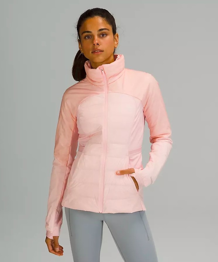 Model wearing pink jacket and gray leggings