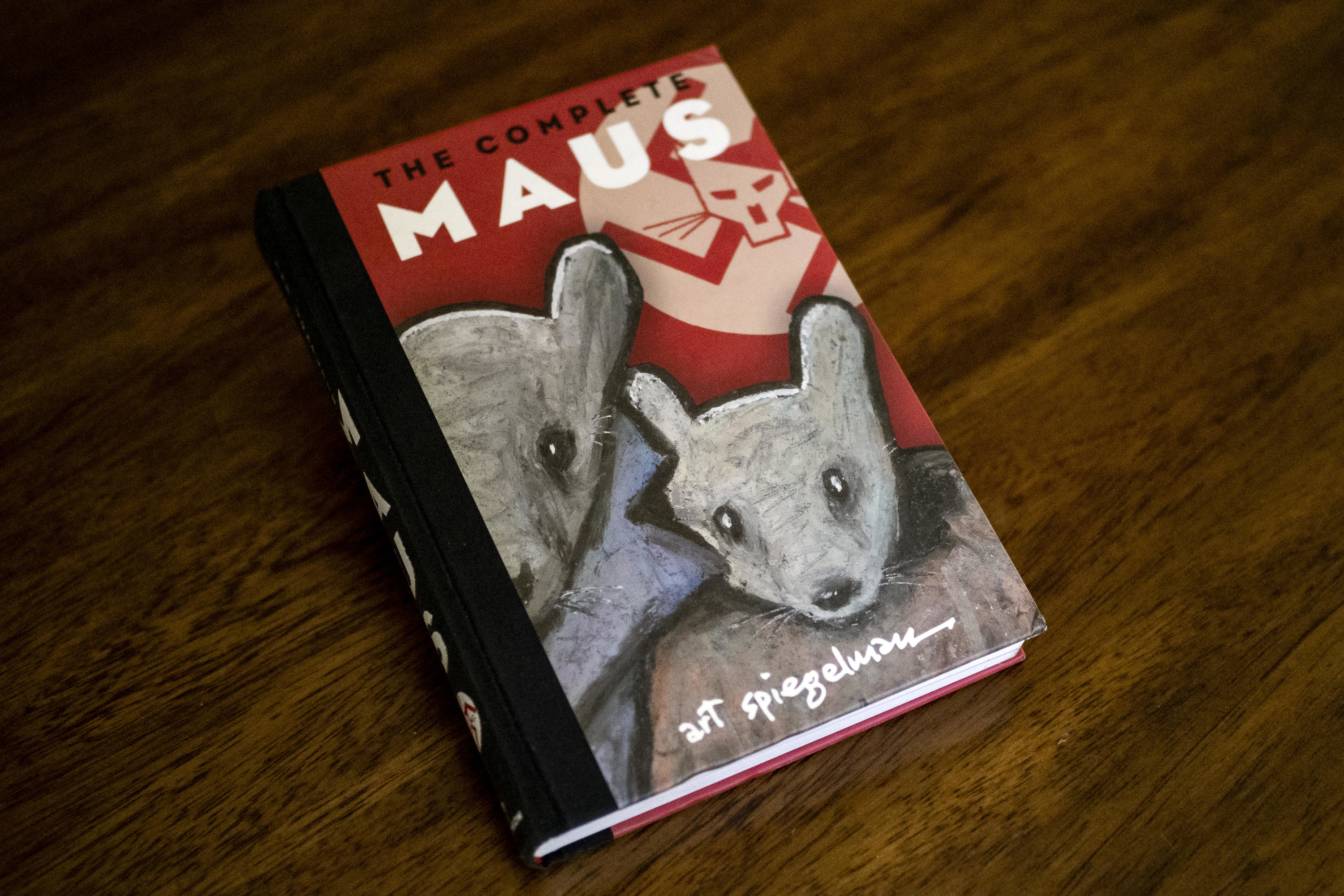 A copy of the book, &quot;Maus,&quot; on a wooden table