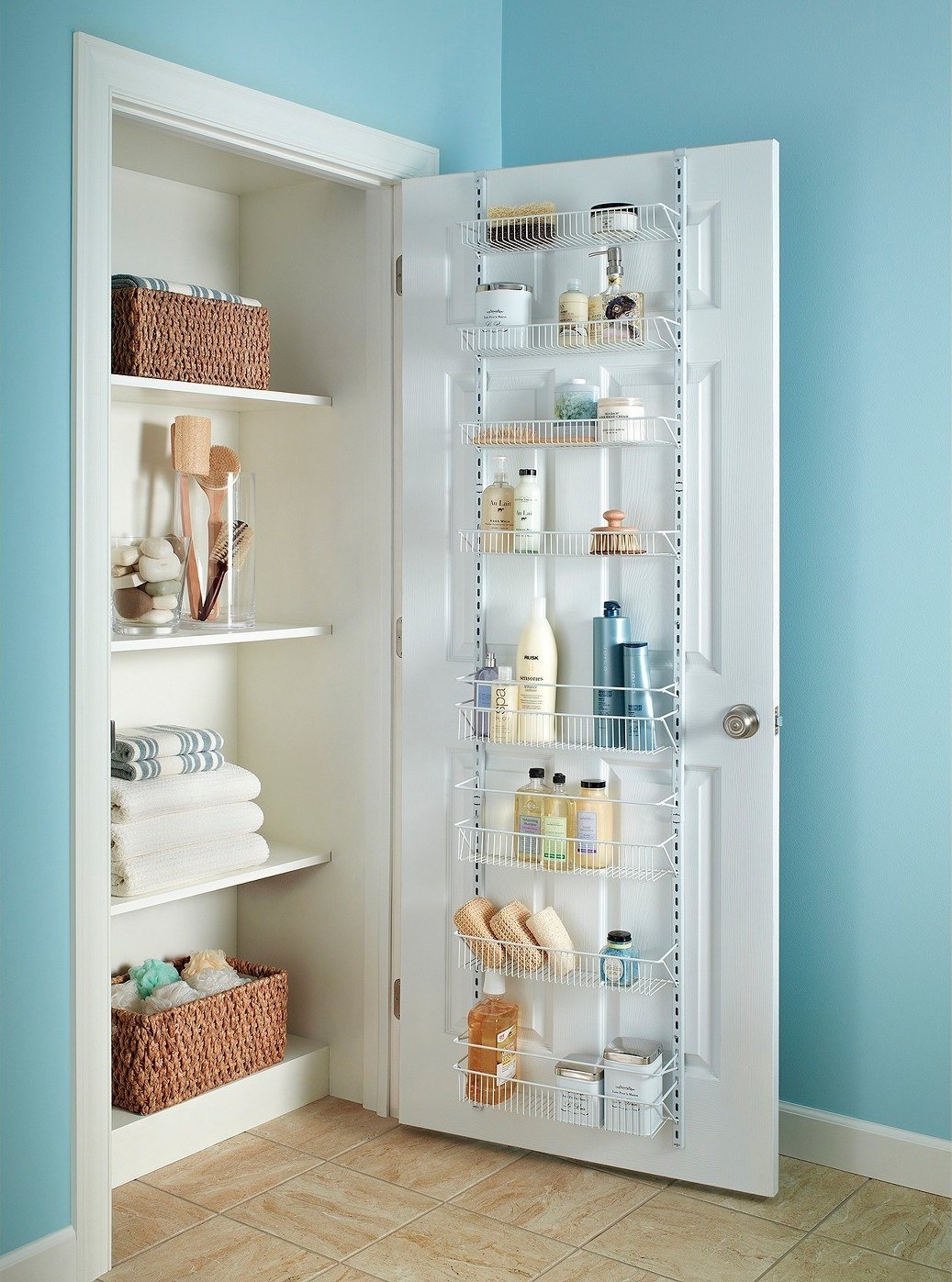 The rack attached to the inside of a linen closet door and stocked with products