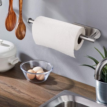 The paper towel holder mounted on a wall