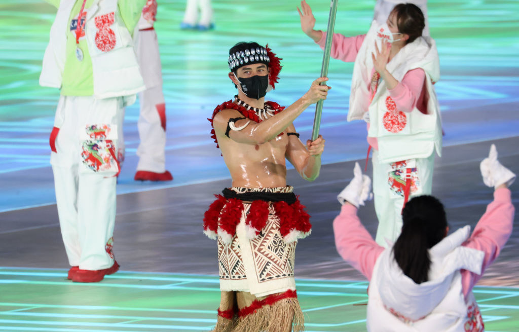 Flag bearer Nathan Crumpton of Team American Samoa carries their flag during the Opening Ceremony