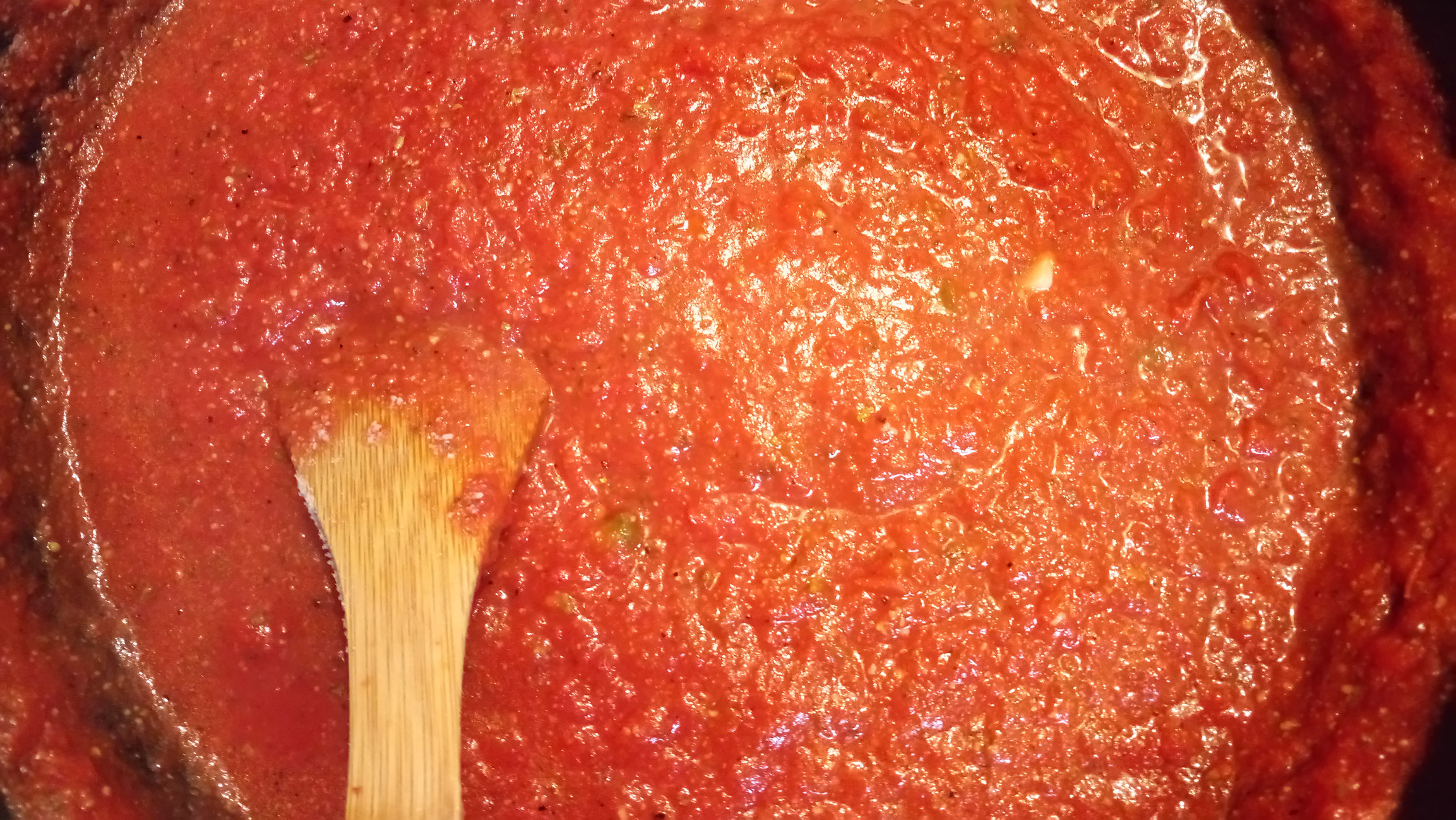 Stirring pasta sauce.
