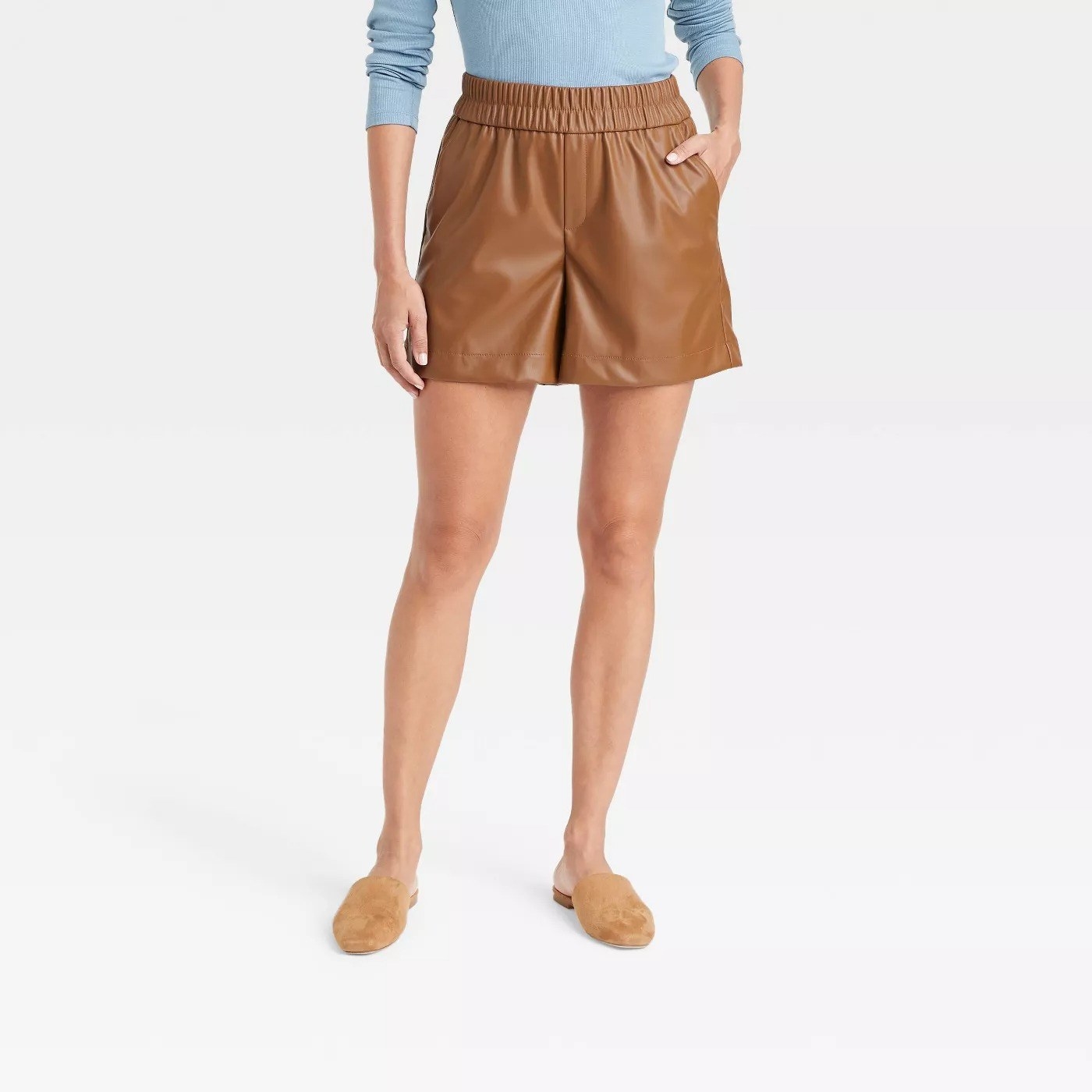 Model wearing camel colored shorts with elastic waistband, stops mid thigh