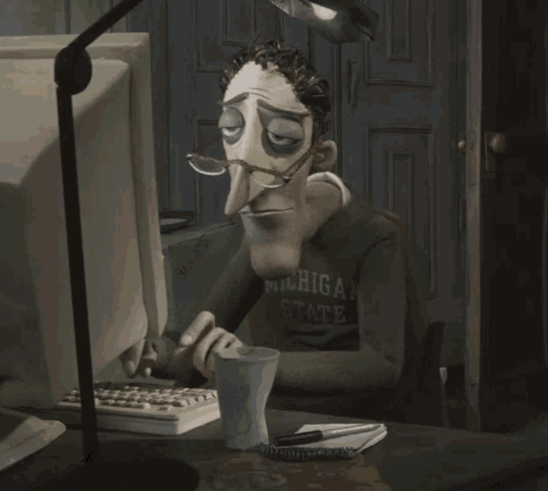 Coraline&#x27;s dad typing sadly at his computer