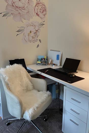 white faux sheepskin rug on an office chair at a desk