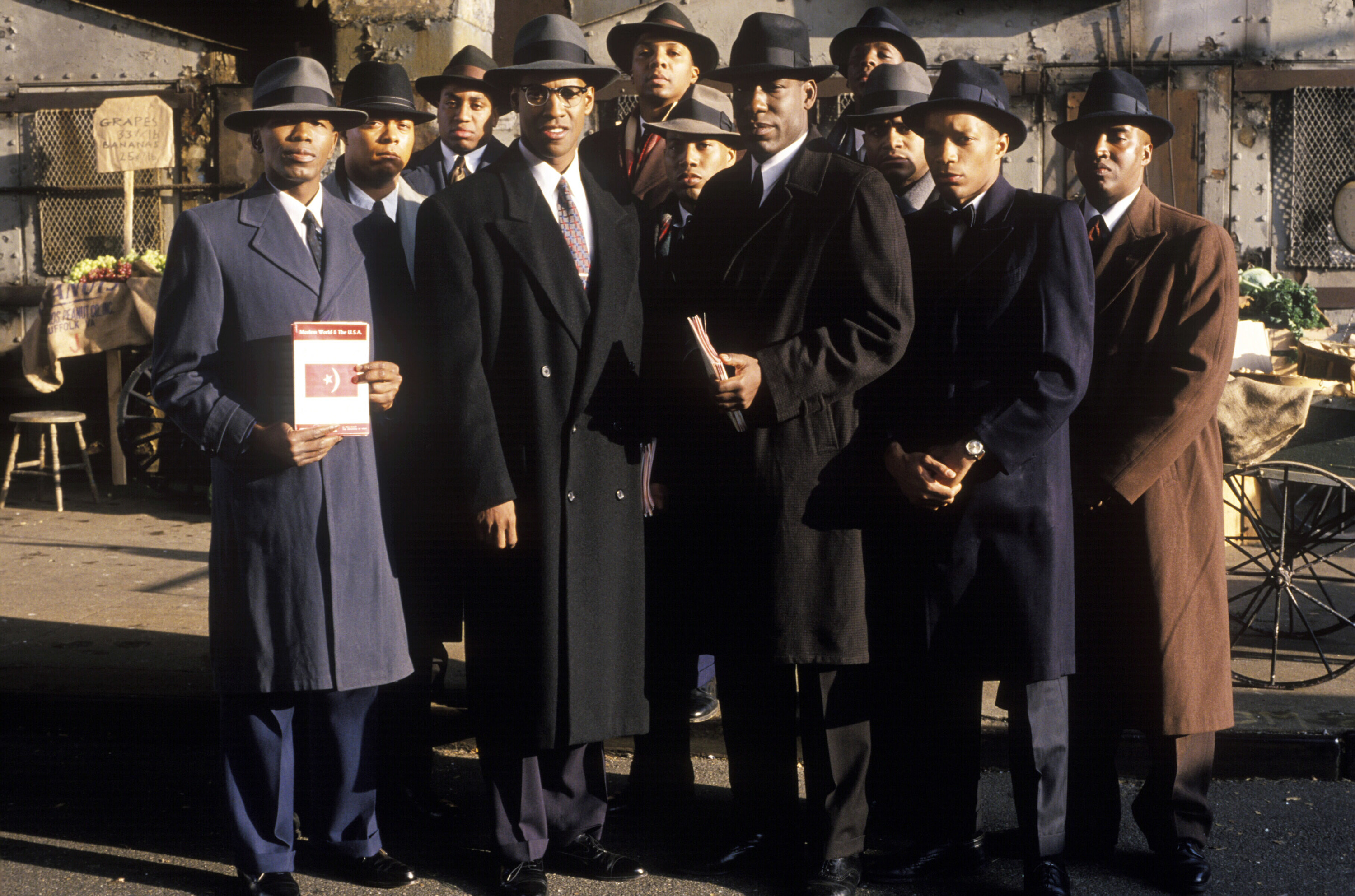 Men in Malcolm X standing in long coats