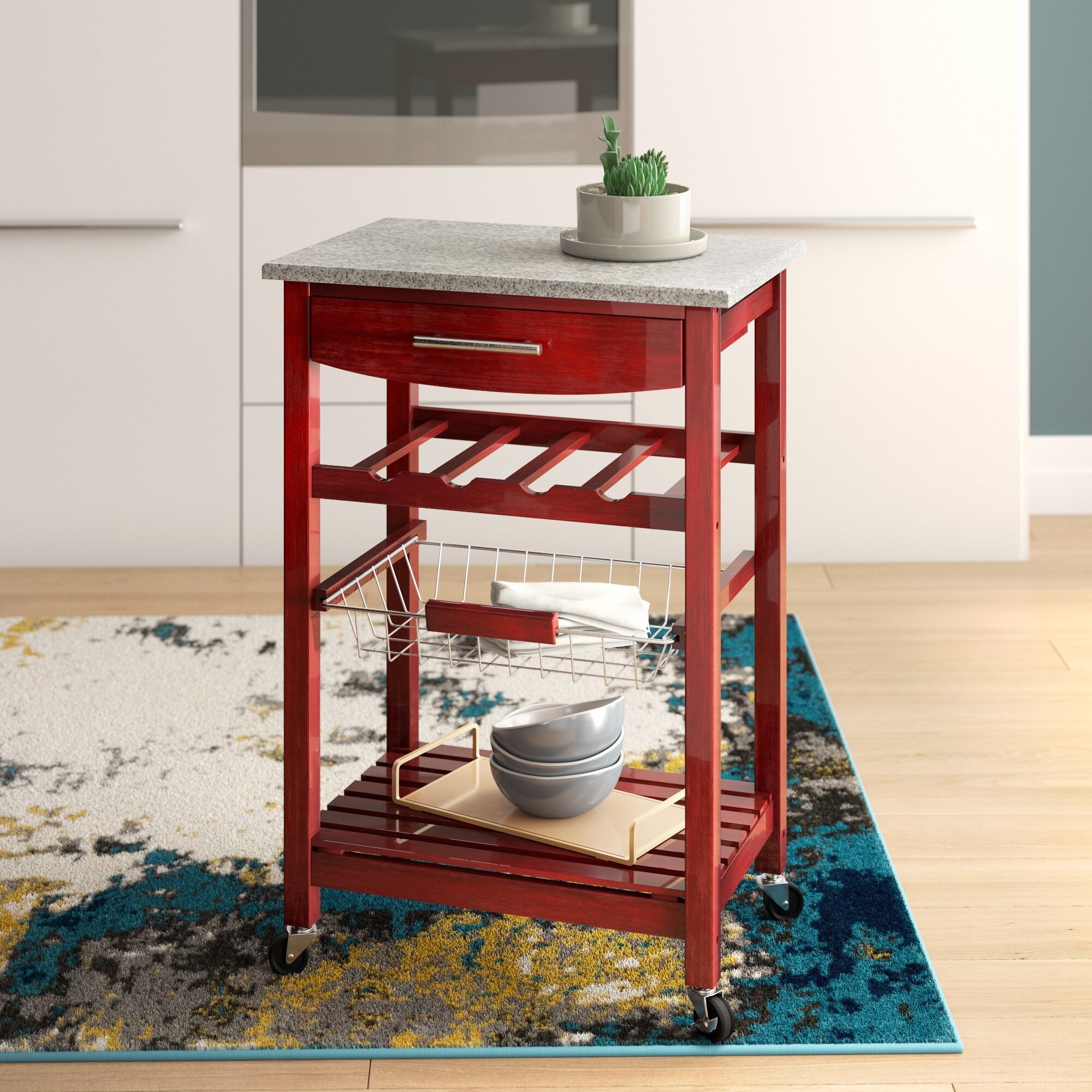 A red wooden kitchen cart with a marble countertop.