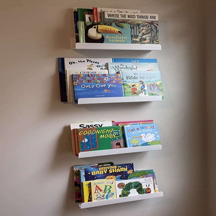 a reviewer photo of three of the shelves on the wall and filled with children's books