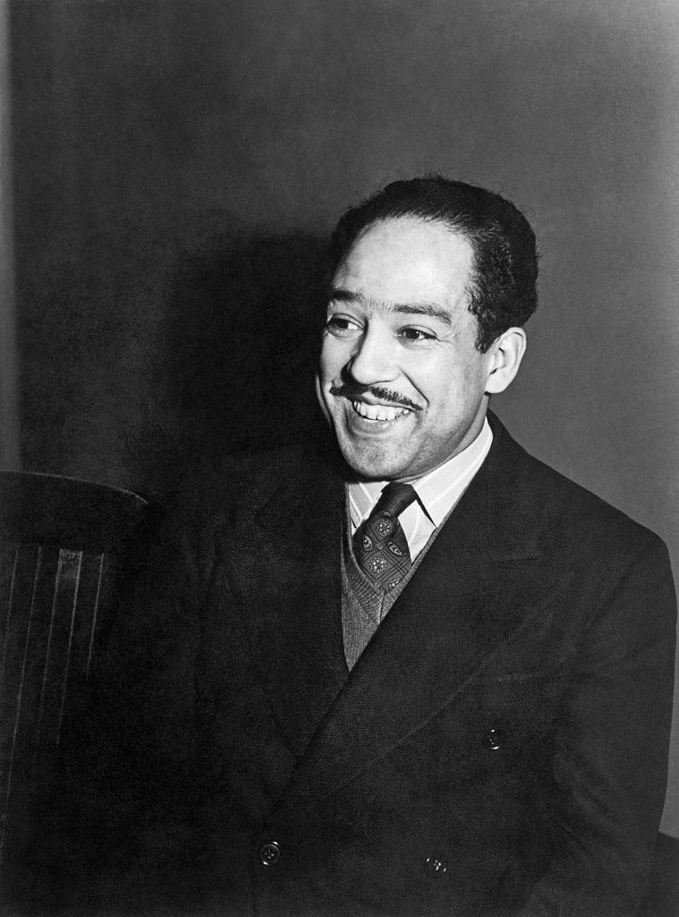 A smiling Black man in a suit and tie