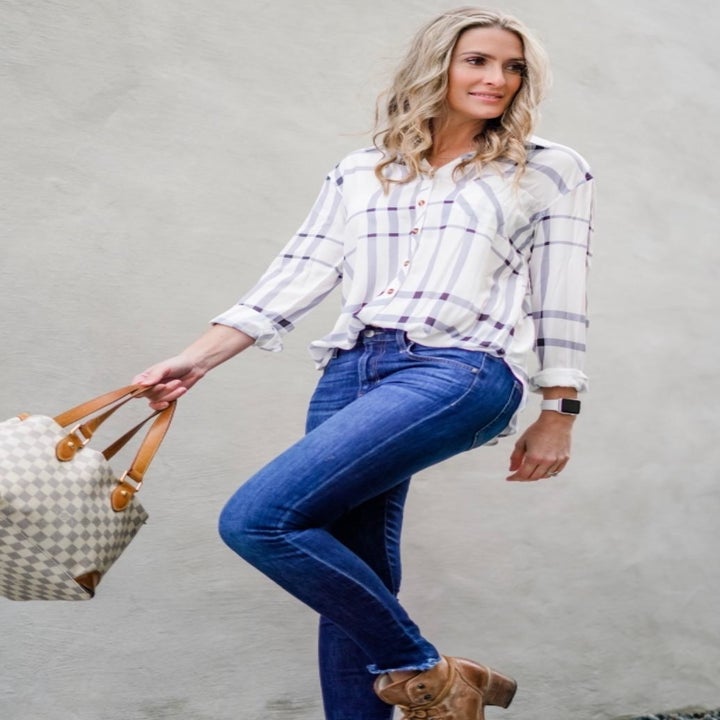 reviewer wearing the white plaid shirt tucked into jeans