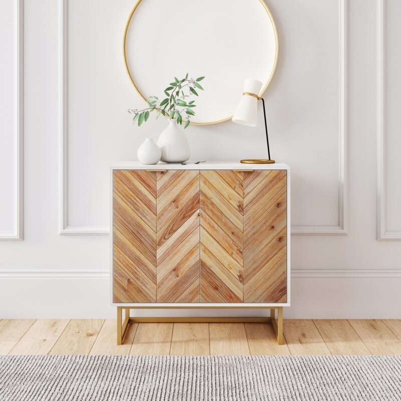 the chevron accent cabinet against a white wall