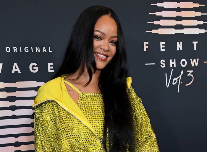 Rihanna smiles on a red carpet
