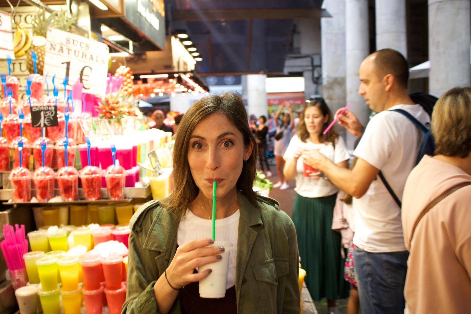 A woman drinking a coconut juice.