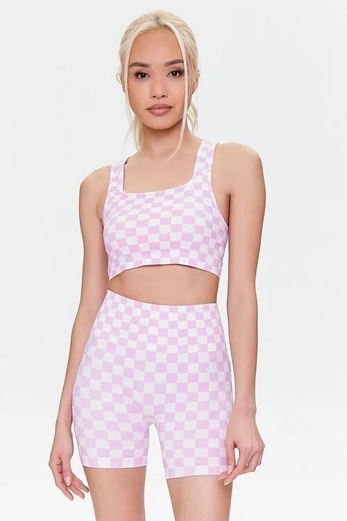 model wearing the pink and white checkered shorts and bra set