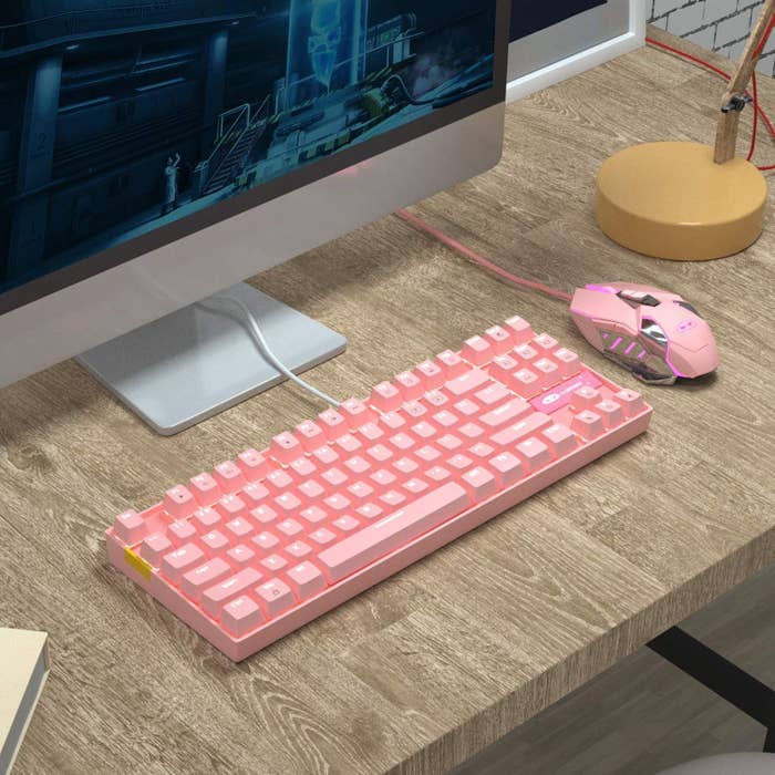 The keyboard on a desk with a matching mouse next to it