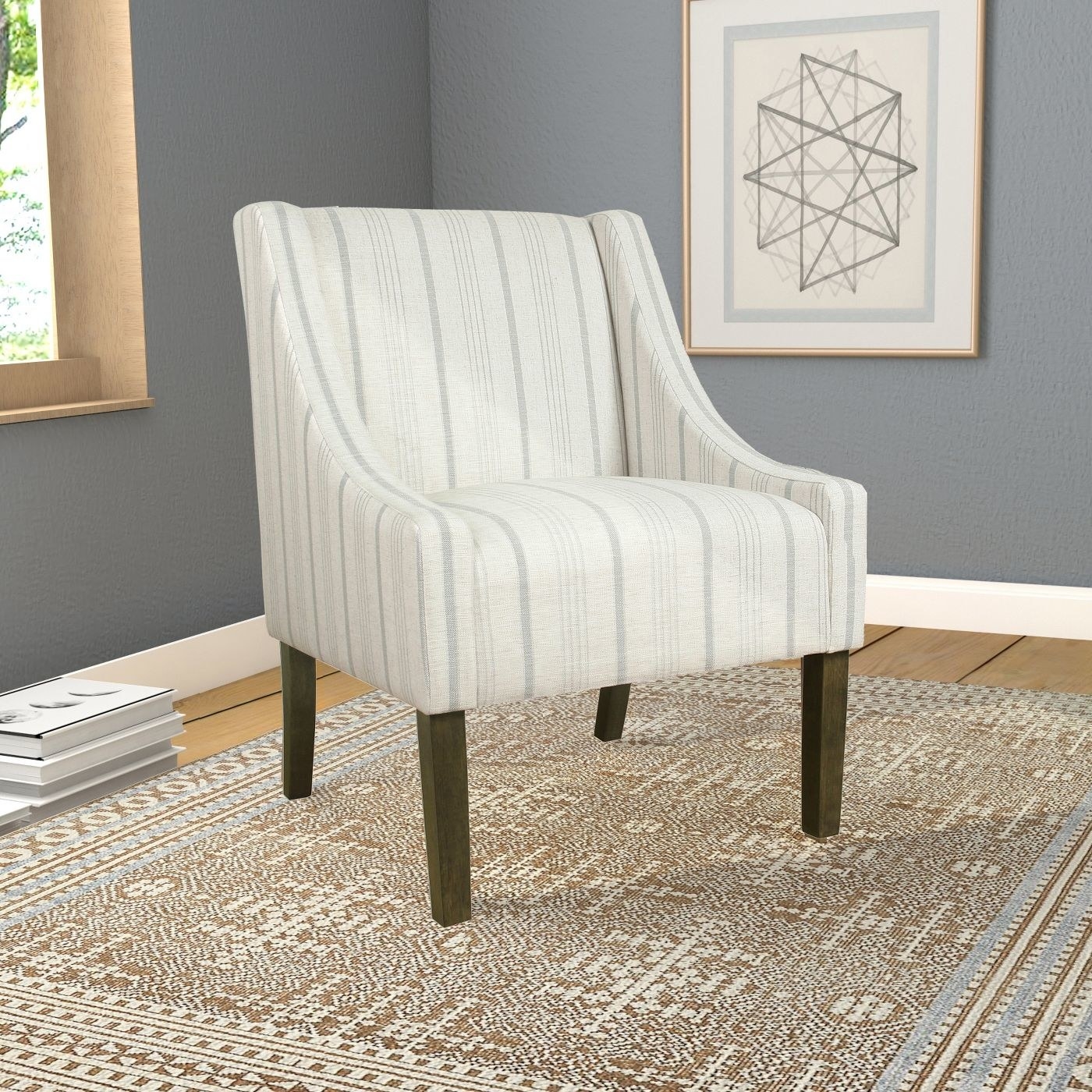gray and white striped swoop armchair with wood legs on a patterned rug