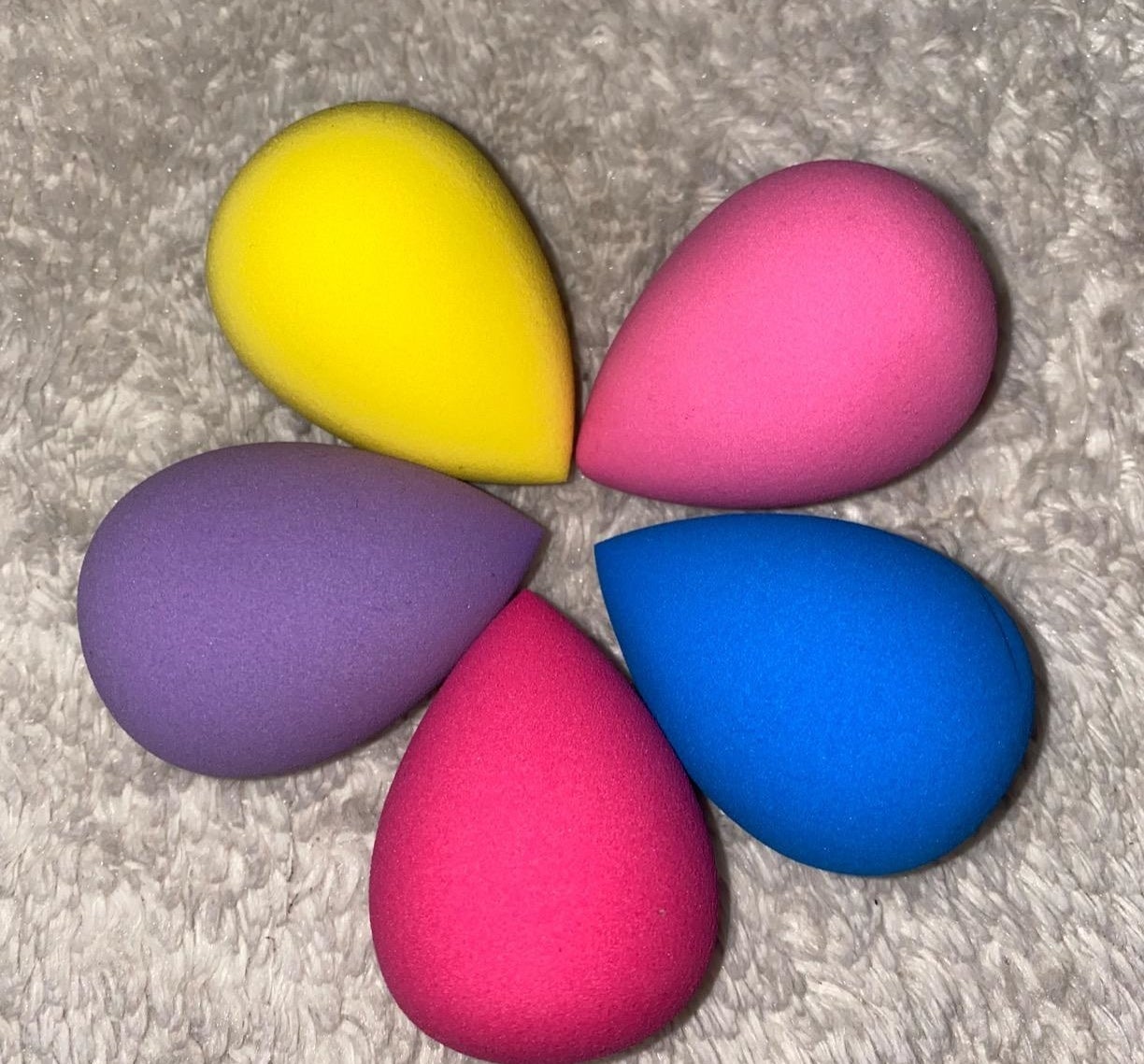 five colorful cone-shaped makeup sponges