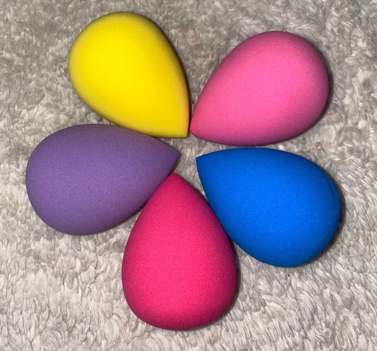 five colorful cone-shaped makeup sponges