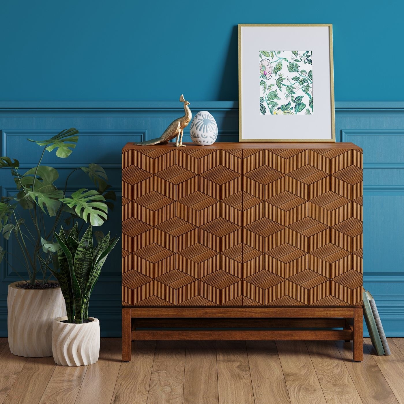 two door wood cabinet with geometric pattern against a teal wall