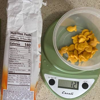 kitchen scale being used to measure goldfish