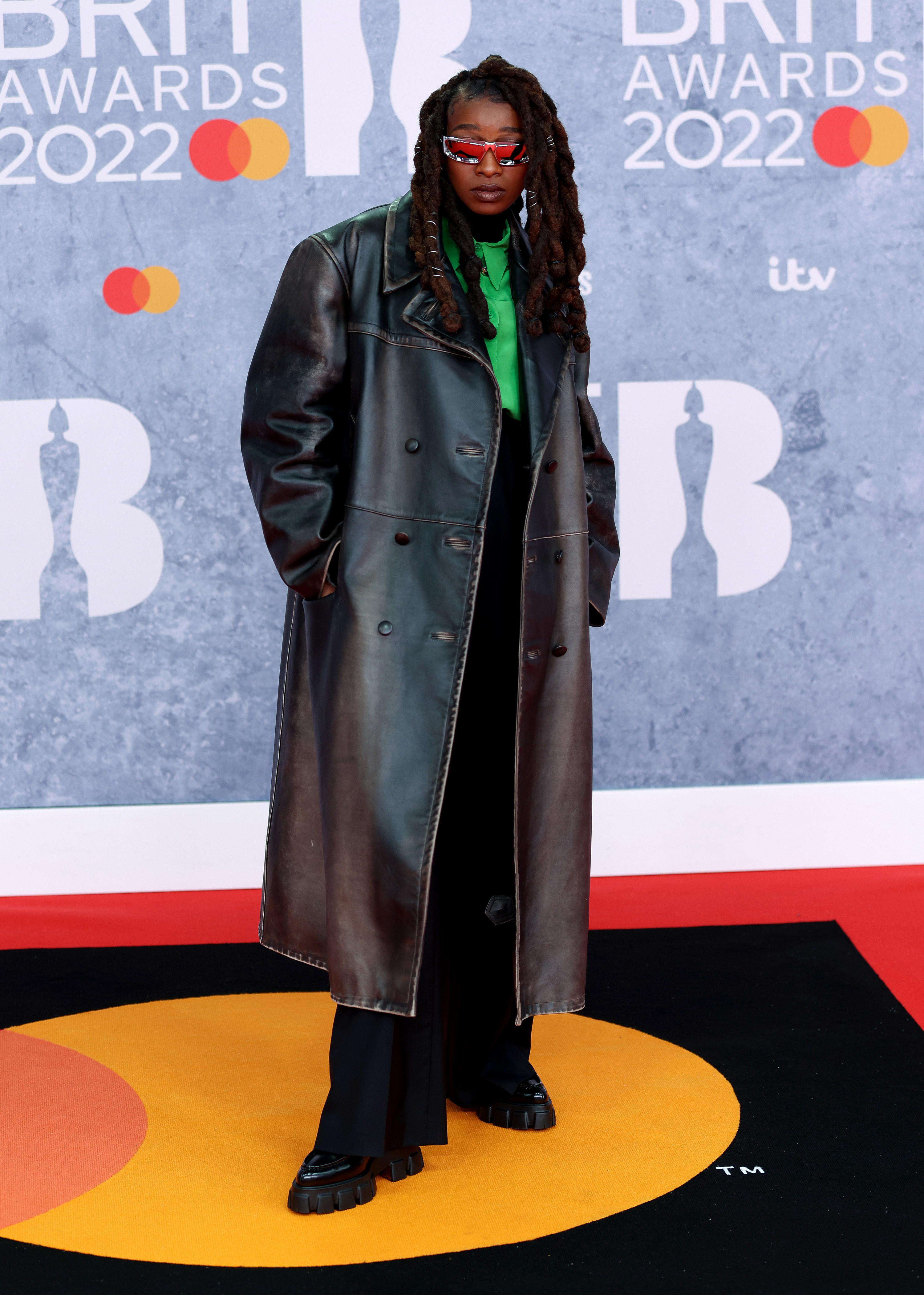 Little Simz wears a long leather trench coat