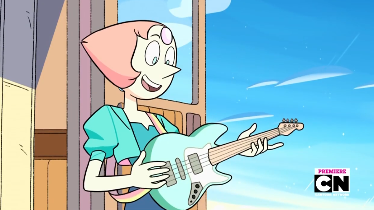 Pearl holding a bass guitar and smiling