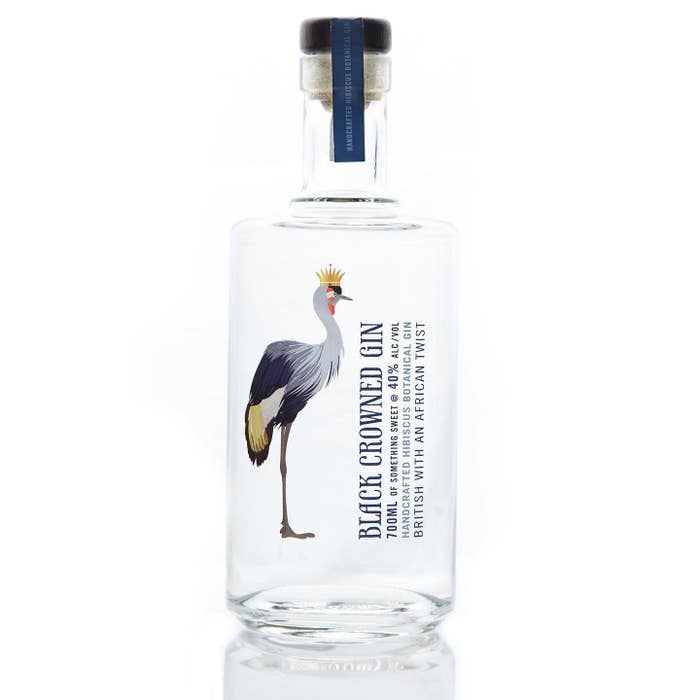 a glass bottle of gin with a crane motif