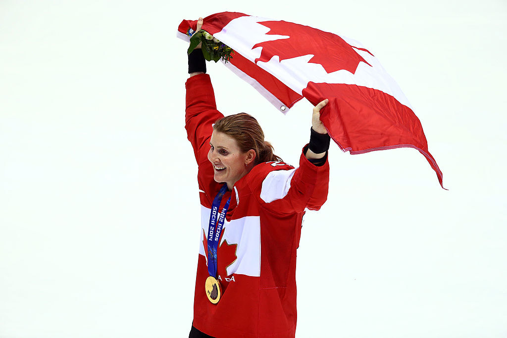 wearing her gold medal, Wickenheiser waves the Canadian flag proudly