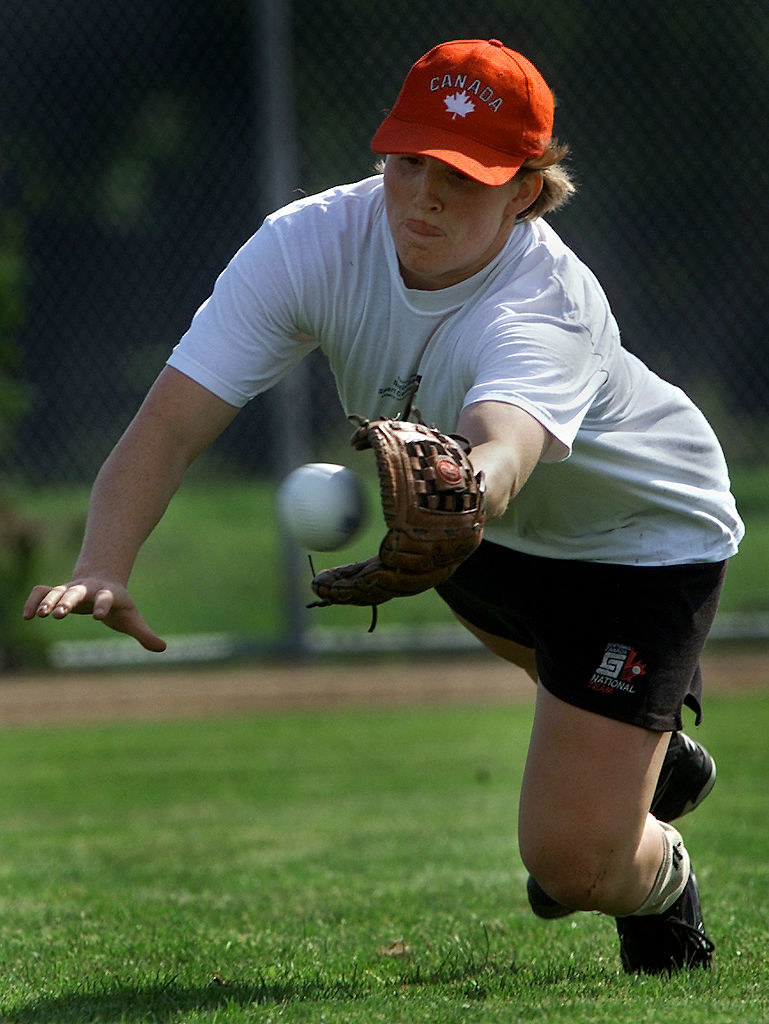 Wickenheiser dives to catch a ball in her mitt