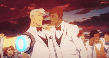 Shiro and his husband kiss in matching white suits as Shiro&#x27;s friends cheer in the background
