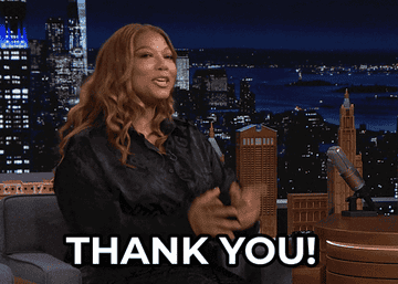 gif of queen latifah pointing at the camera and saying thank you
