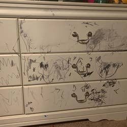 reviewer image of a white dresser covered in black permanent marker scribbles