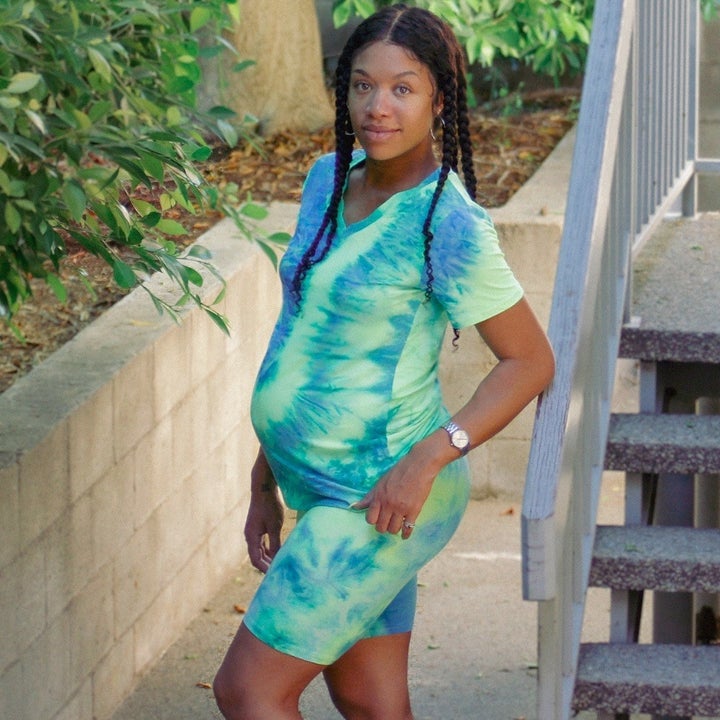 reviewer wearing the green and blue tie dye set