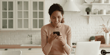 Woman gets excited while looking at phone