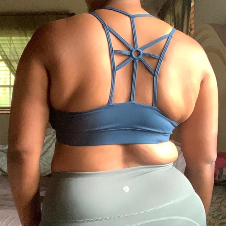 back of reviewer wearing the blue bra to show the strap pattern
